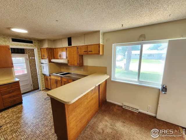 a kitchen with stainless steel appliances granite countertop a stove and a refrigerator