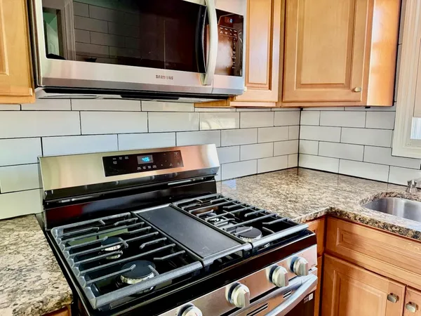 a kitchen with a stove and a microwave