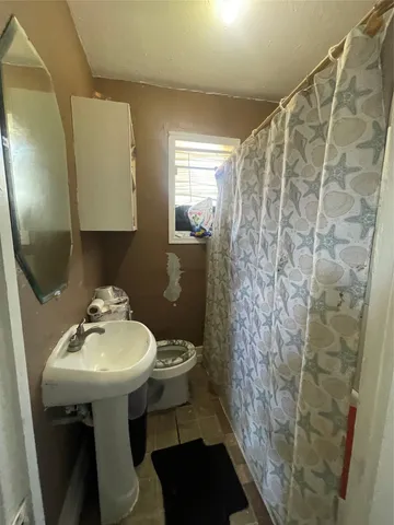 a bathroom with a sink toilet and mirror