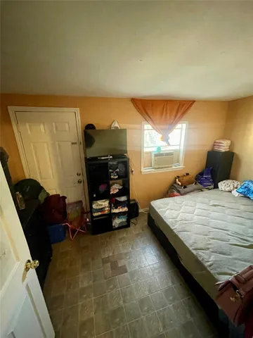 a bed sitting in a room next to a window