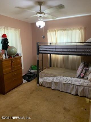 7016 Oakney Road Jacksonville, FL 32211 - Photo 13 of 16 a bedroom with a bed and cabinets