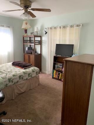 7016 Oakney Road Jacksonville, FL 32211 - Photo 14 of 16 a bedroom with a bed and a flat screen tv