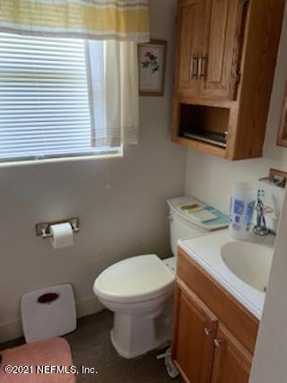 7016 Oakney Road Jacksonville, FL 32211 - Photo 15 of 16 a white toilet sitting next to a bathroom sink