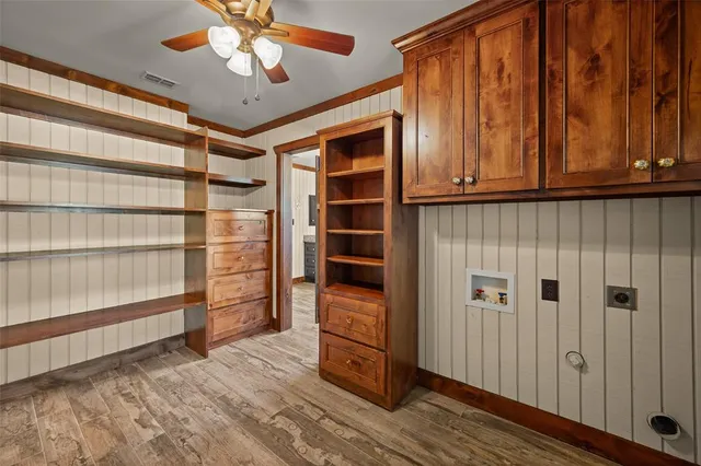 a view of a livingroom with wooden floor and stairs