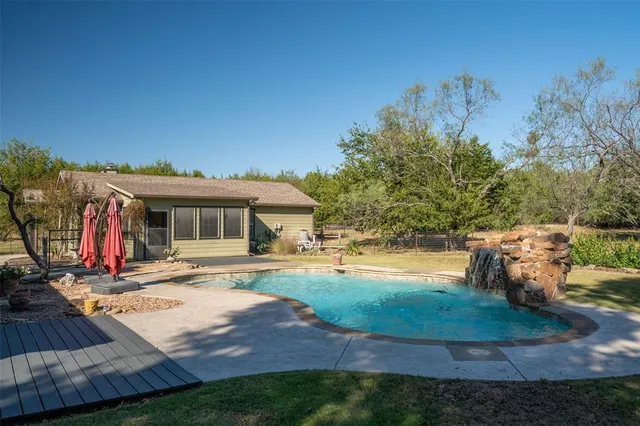 a living room with fireplace furniture and a large window