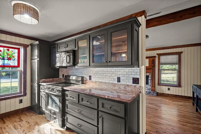 a kitchen with stainless steel appliances granite countertop a stove and a sink