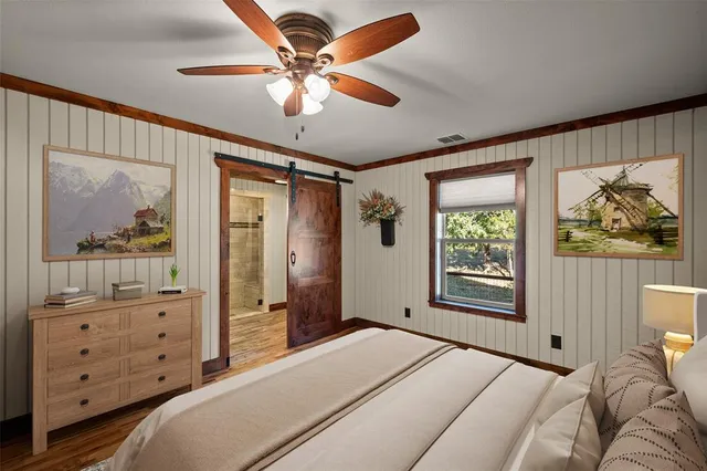 a bedroom with a large bed and a window