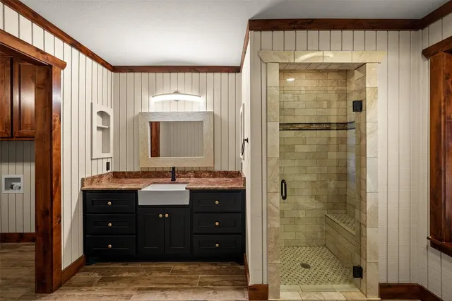 a bathroom with a granite countertop toilet sink and mirror