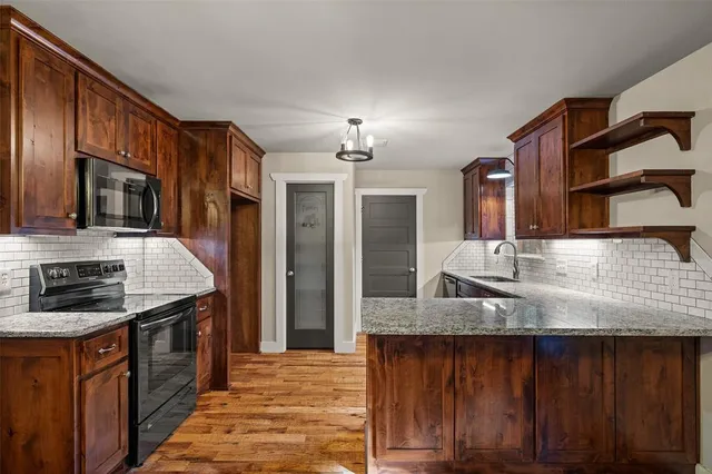 a view of backyard with wooden fence and large trees