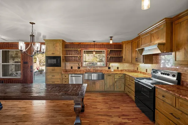 a view of a dining room with furniture and chandelier