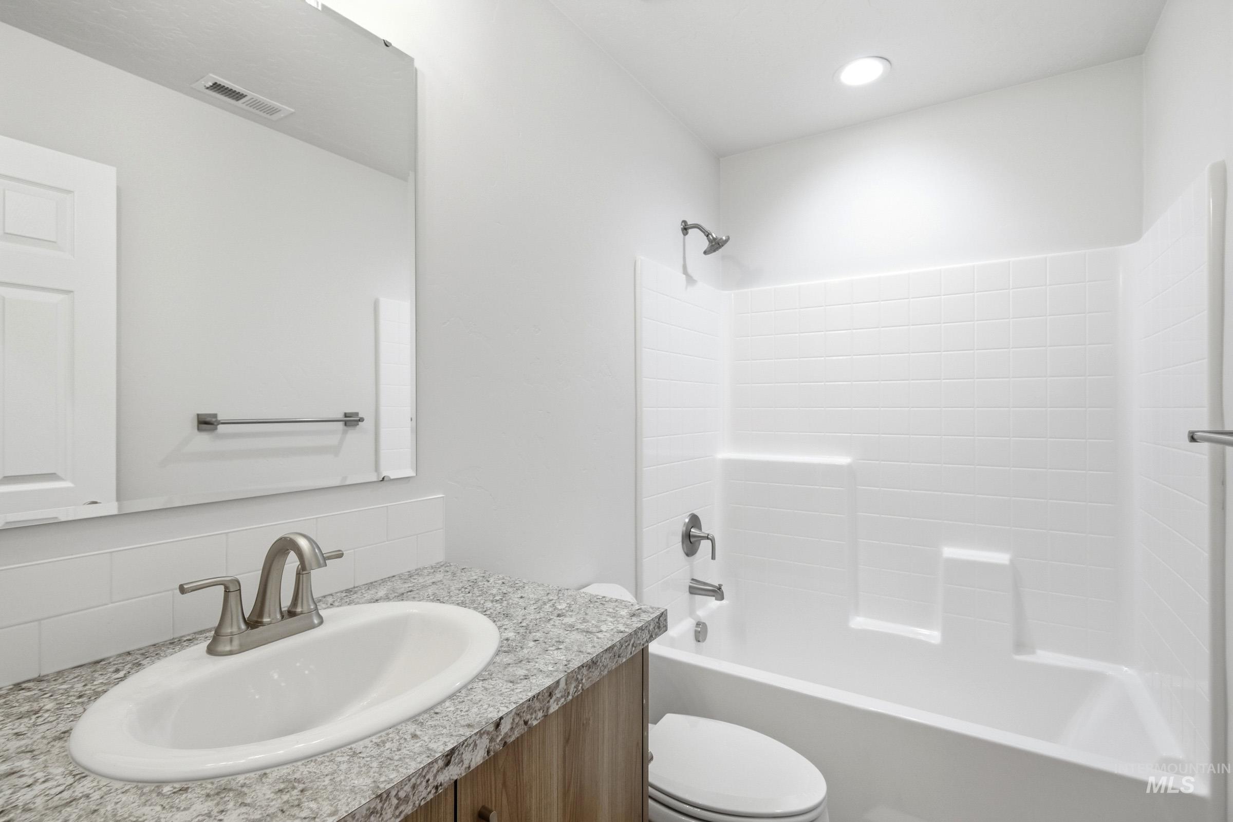 13735 Inman Court Caldwell, ID 83607 - Photo 13 of 20 Full bath featuring shower / bathtub combination, vanity, and tasteful backsplash