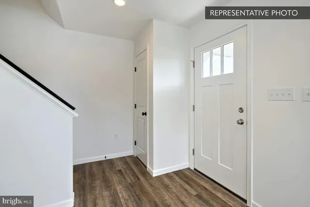 a view of an entryway with wooden floor