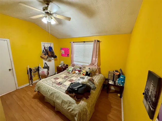 a bedroom with a bed furniture and a flat screen tv