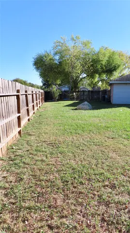 a view of a backyard with plants and lake view
