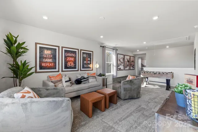 a living room with furniture and potted plant