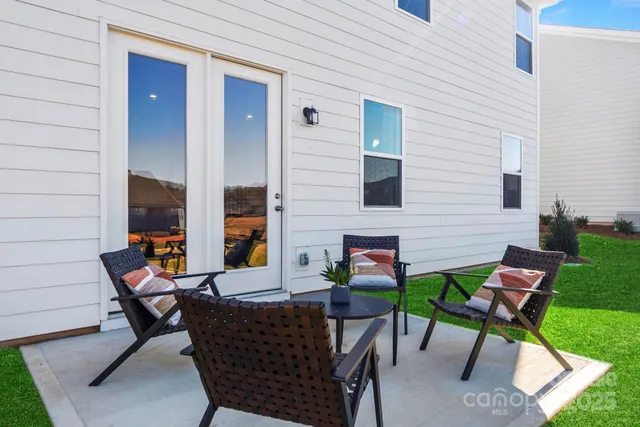 a backyard of a house with outdoor seating