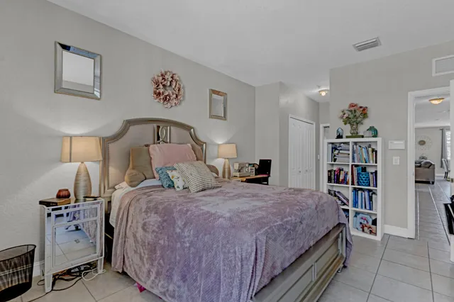 a bedroom with a bed and a book shelf