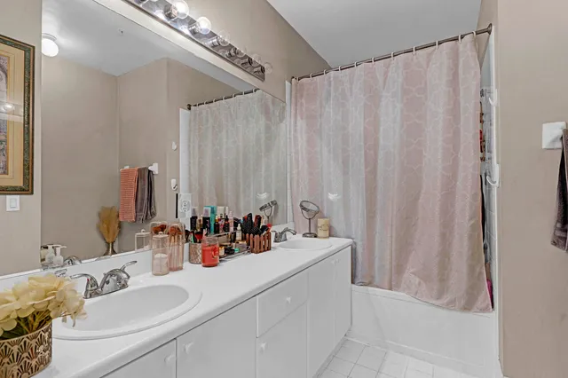 a bathroom with a double vanity sink and a mirror