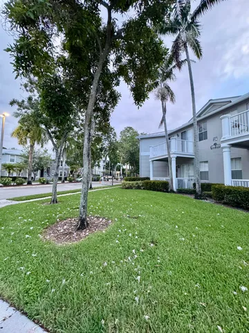 a view of a house with a tree in a yard