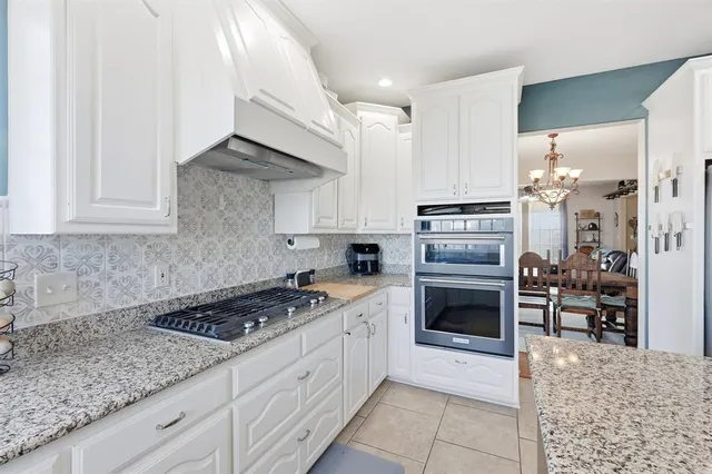 a kitchen with cabinets appliances and a counter space