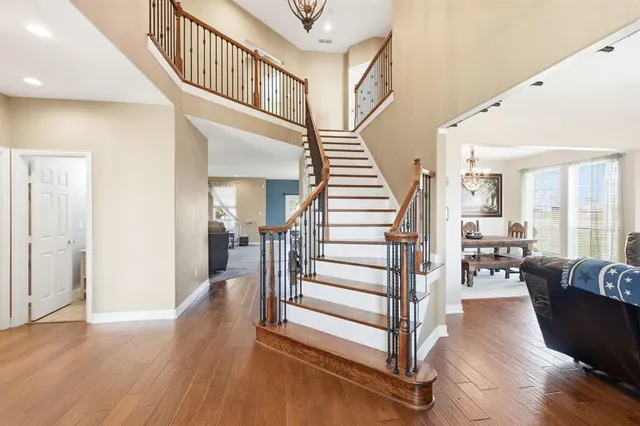 a view of entryway and hall with wooden floor