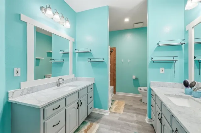 a bathroom with a double vanity sink and a mirror