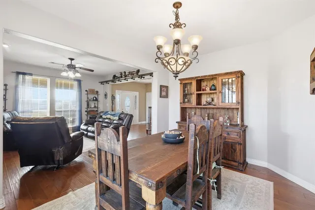 a view of a dining room with furniture and chandelier