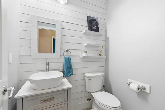 a bathroom with a toilet a sink and mirror