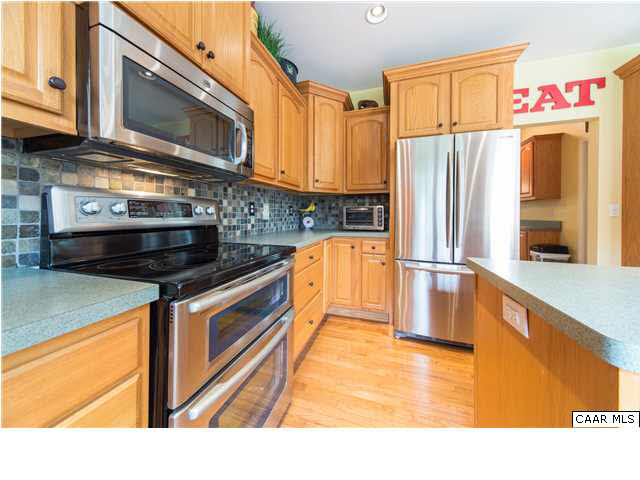 6725 Amicus Road Ruckersville, VA 22968 - Photo 11 of 50 a kitchen with stainless steel appliances granite countertop a stove a sink and a microwave