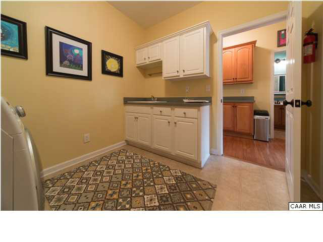 6725 Amicus Road Ruckersville, VA 22968 - Photo 18 of 50 a room with wooden floor and white cabinets