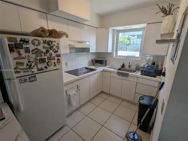 a kitchen with stainless steel appliances a sink stove and refrigerator
