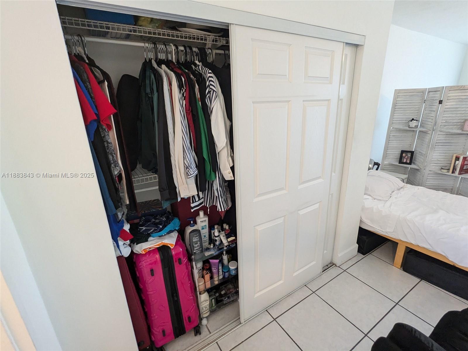 158 Ocean Drive, Unit 406 Miami Beach, FL 33139 - Photo 5 of 6 a view of walk in closet with clothes and shoes