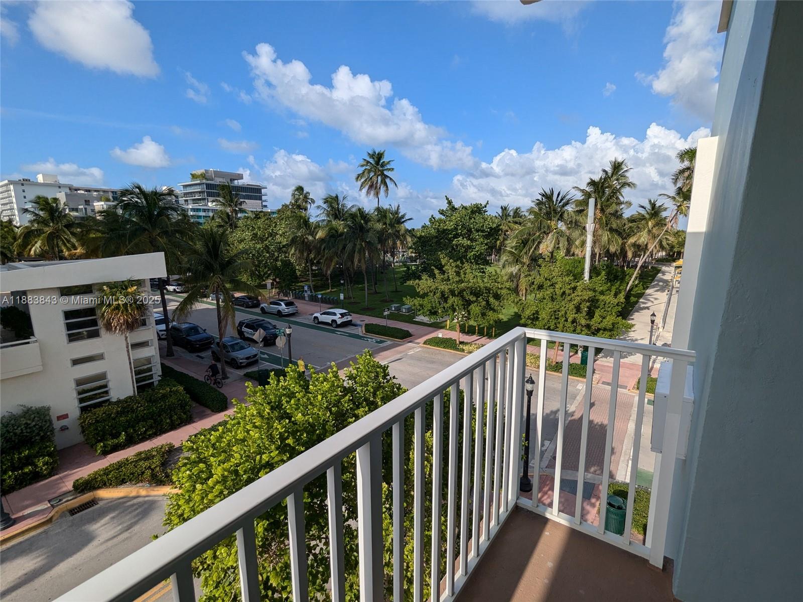 158 Ocean Drive, Unit 406 Miami Beach, FL 33139 - Photo 6 of 6 a balcony with wooden floor and city view