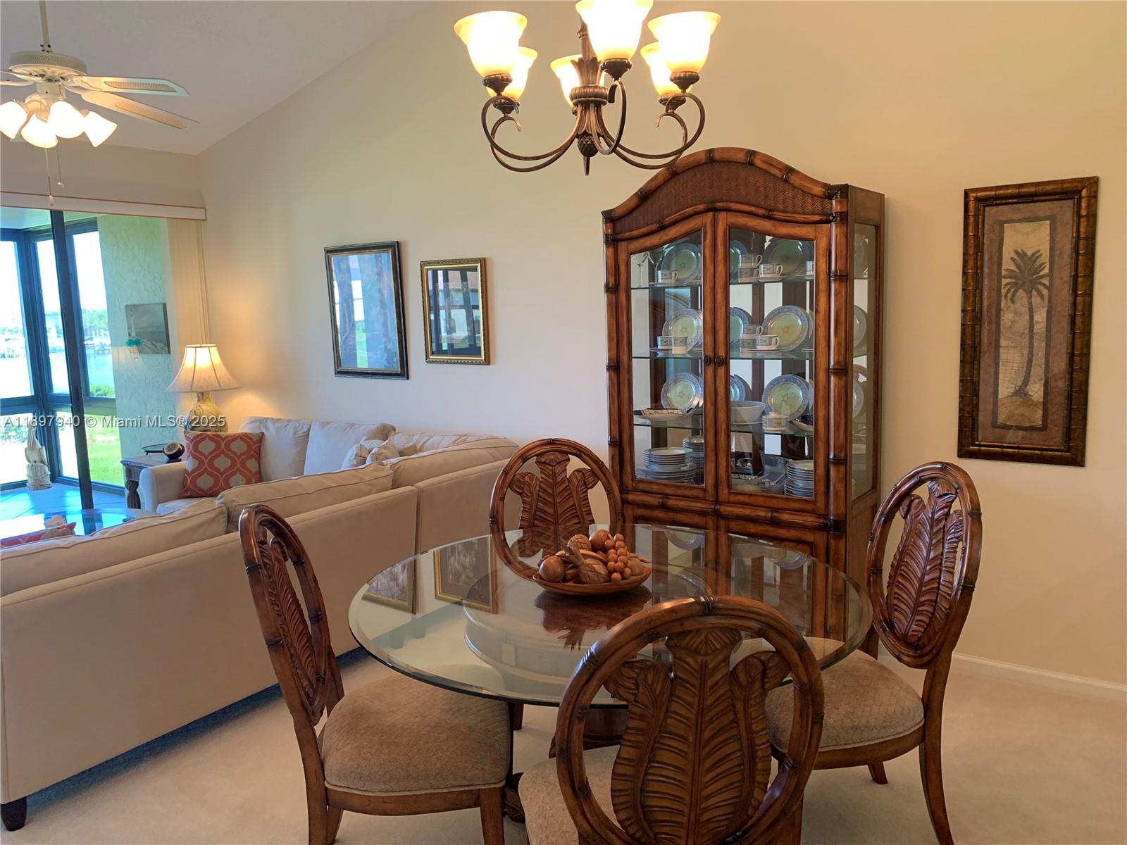6062 Southeast Landing Way, Unit 15 Stuart, FL 34997 - Photo 11 of 43 a view of a dining room with furniture and chandelier