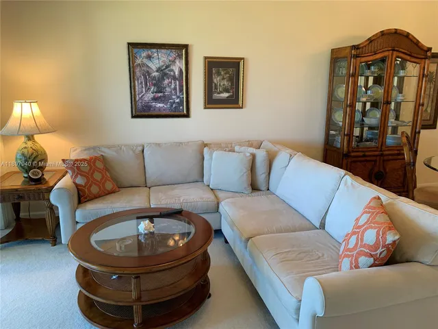 a living room with furniture and a mirror