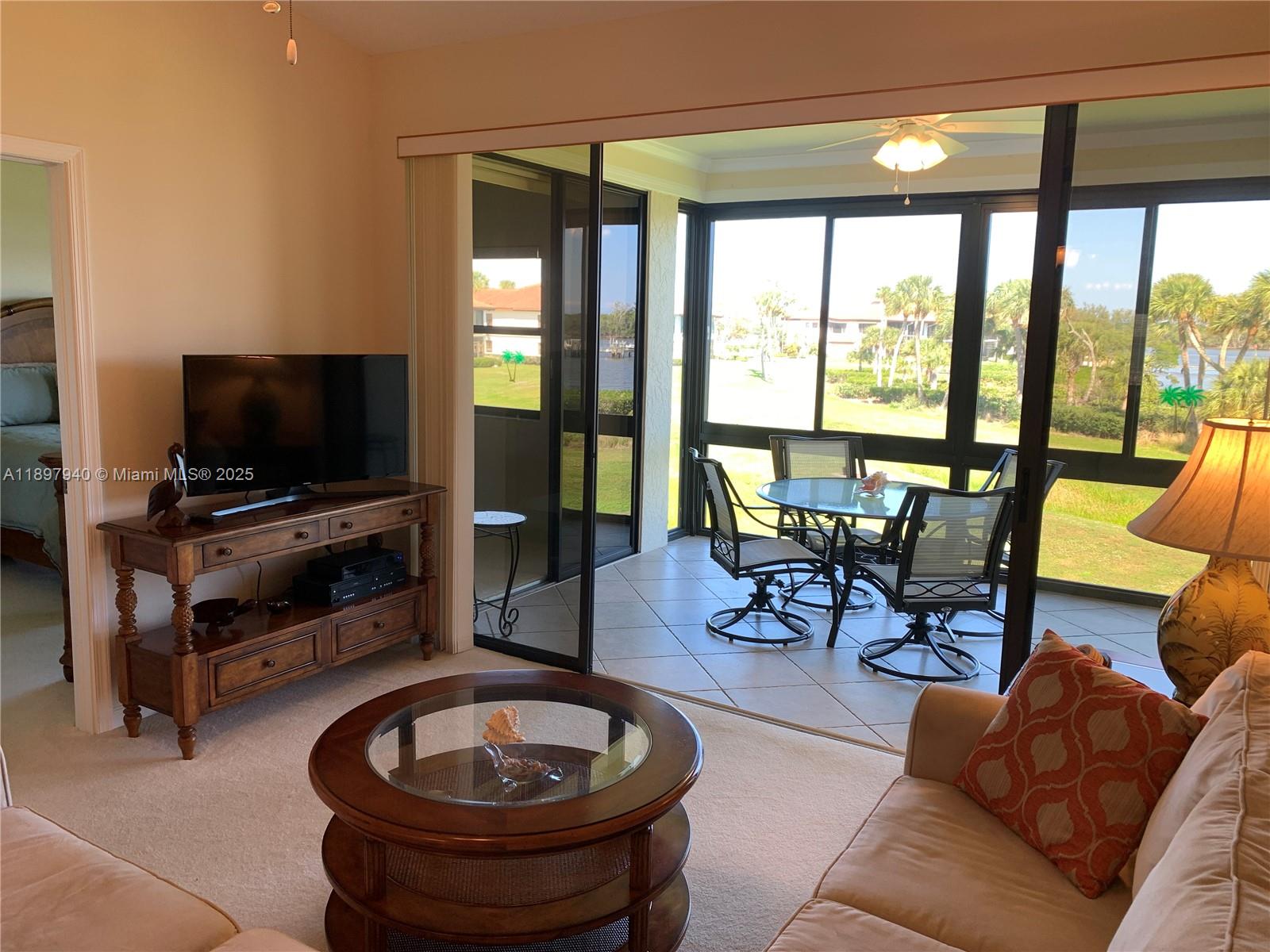 6062 Southeast Landing Way, Unit 15 Stuart, FL 34997 - Photo 14 of 43 a living room with furniture and a flat screen tv
