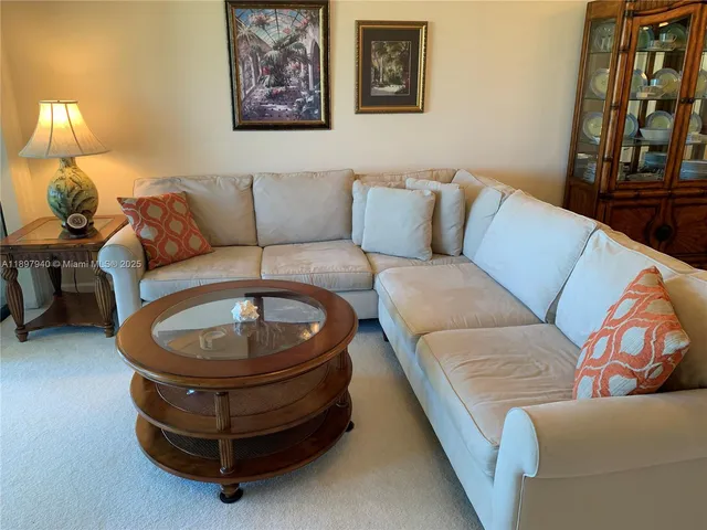 a living room with furniture and a lamp