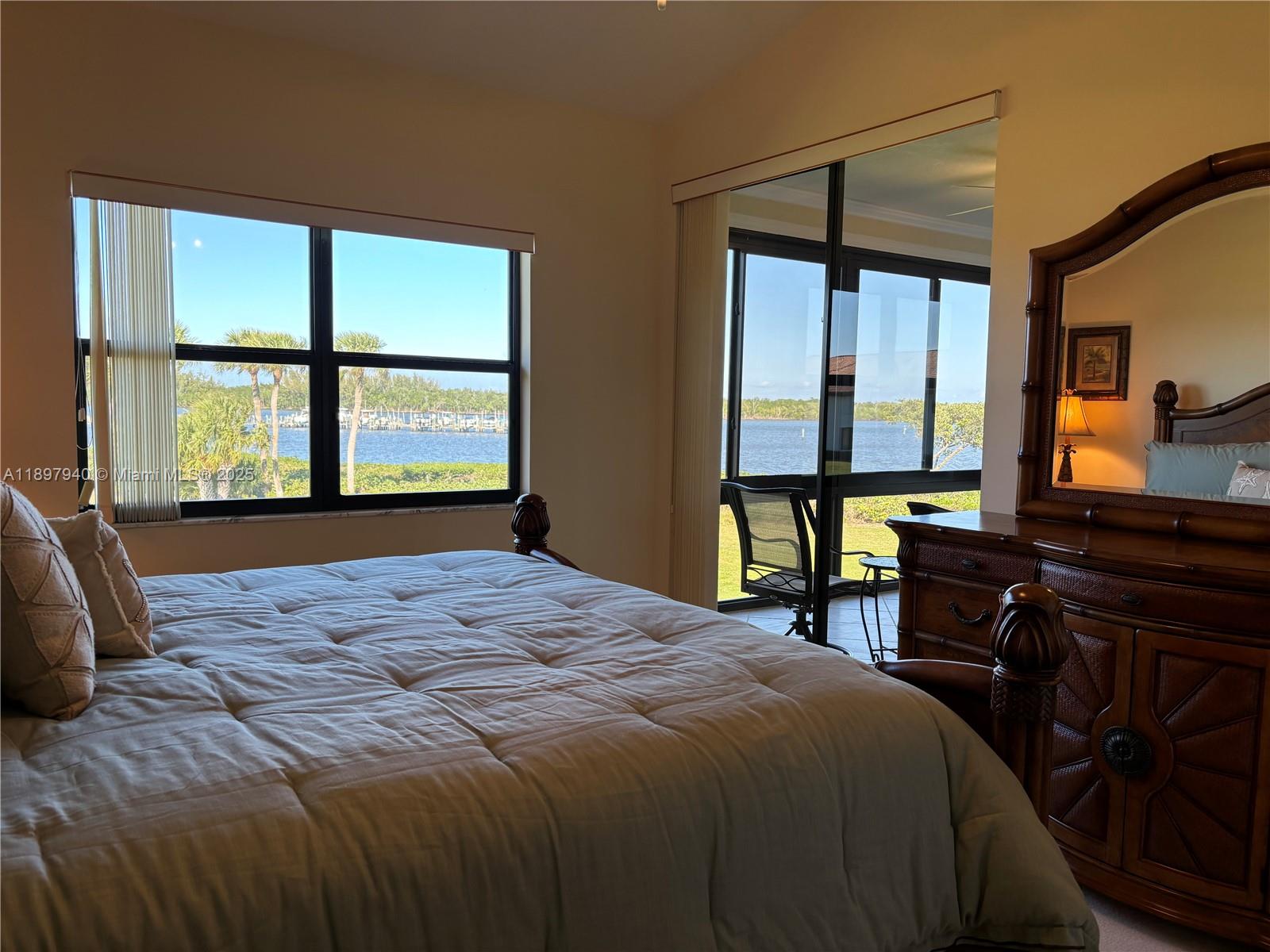 6062 Southeast Landing Way, Unit 15 Stuart, FL 34997 - Photo 25 of 43 a bedroom with a large bed and a window