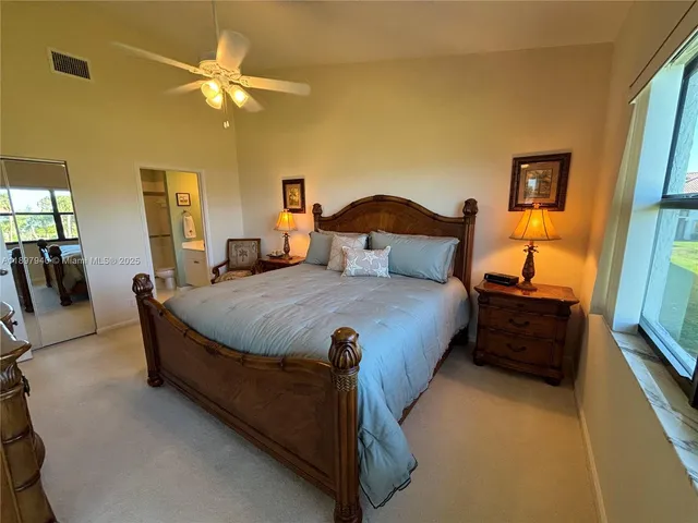a spacious bedroom with a bed and a chandelier