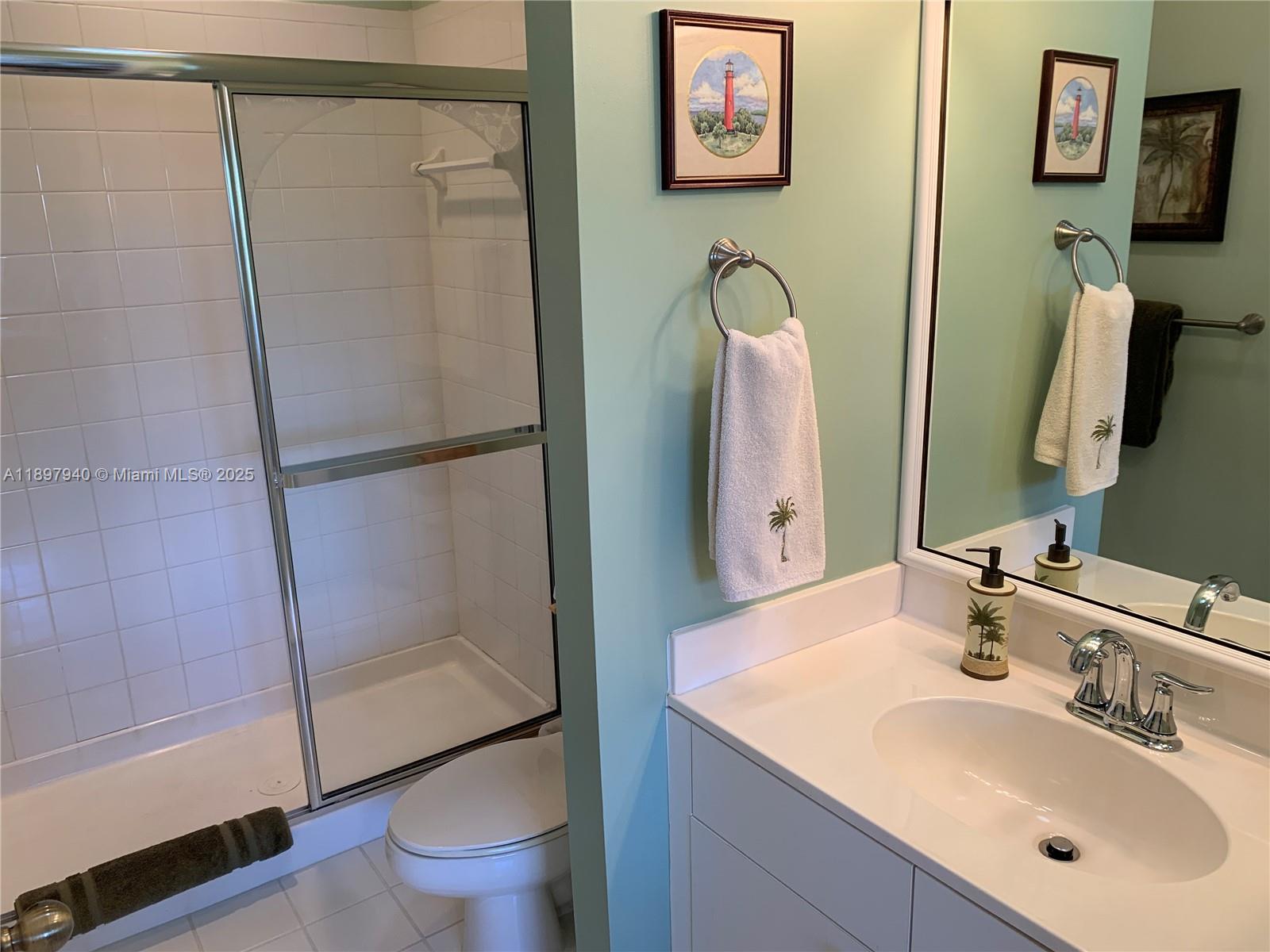 6062 Southeast Landing Way, Unit 15 Stuart, FL 34997 - Photo 28 of 43 a bathroom with a sink toilet and shower