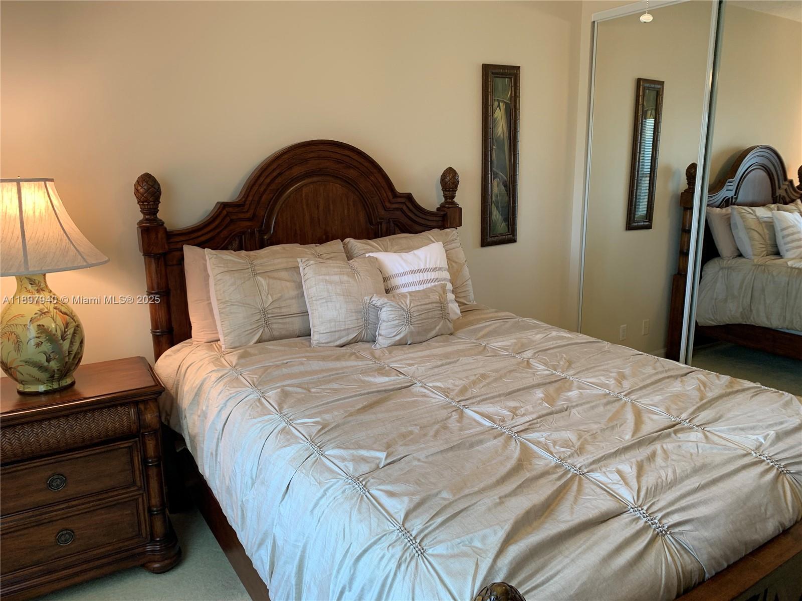 6062 Southeast Landing Way, Unit 15 Stuart, FL 34997 - Photo 30 of 43 a bedroom with a bed and dresser