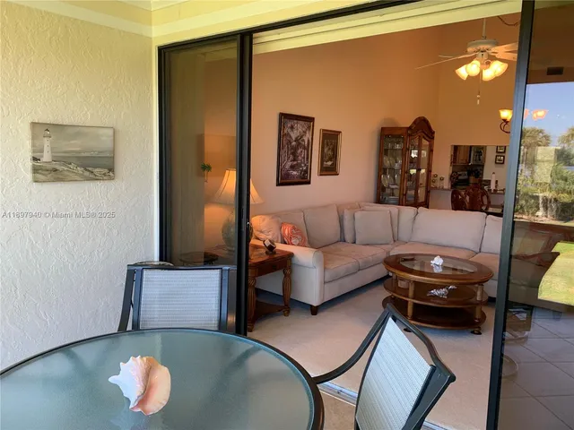 a living room with furniture and a lamp