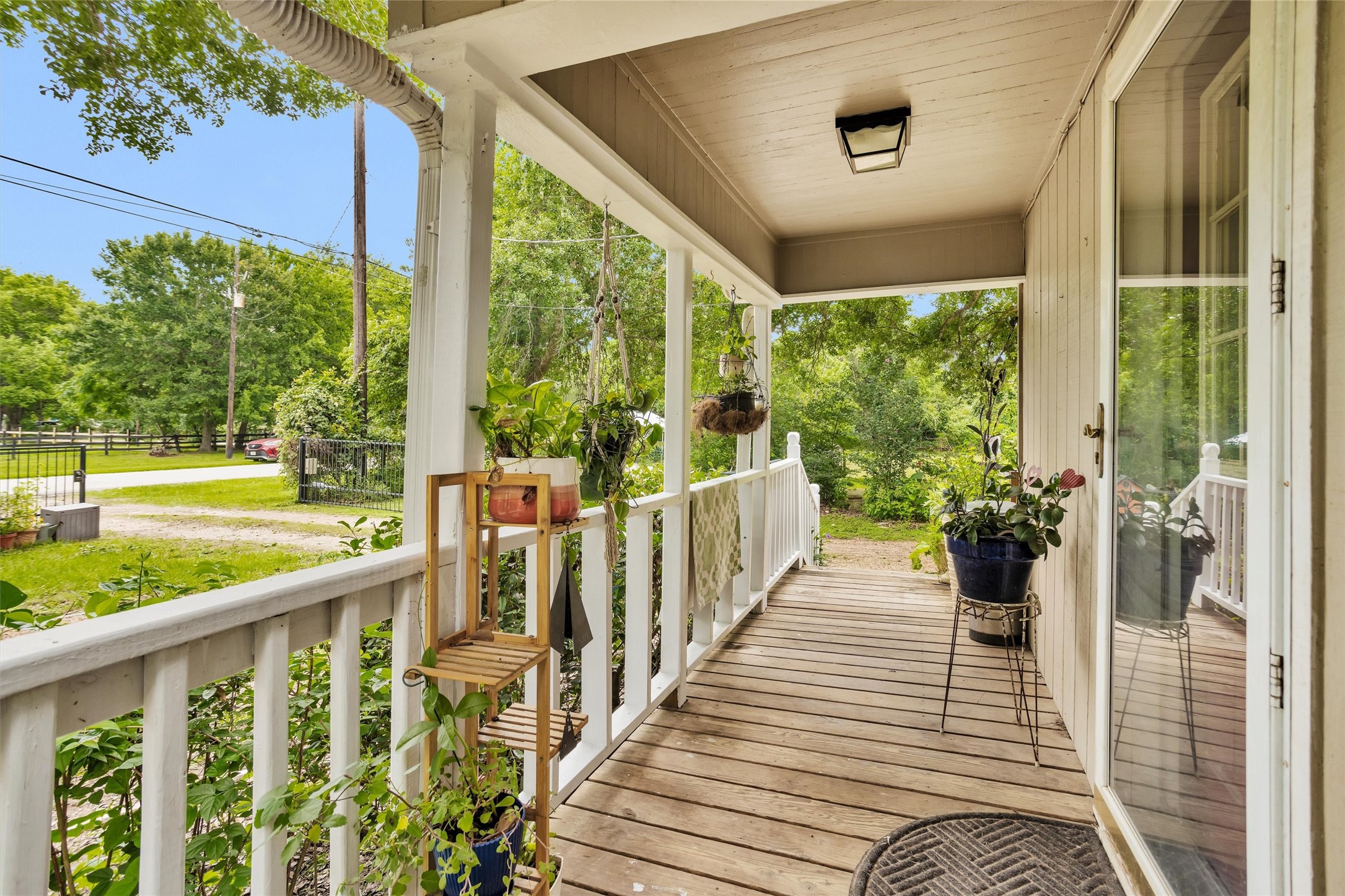 32117 Old Hempstead Road Magnolia, TX 77355 - Photo 3 of 26 Quaint covered porch of this updated 60's built cottage farmhouse. Surrounded by oaks, fruit trees, and mature flowering plants like Rose of Sharon.