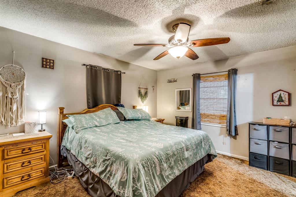 2912 Farm To Market 920 Weatherford, TX 76088 - Photo 13 of 28 Bedroom with a textured ceiling, carpet flooring, a ceiling fan, and baseboards