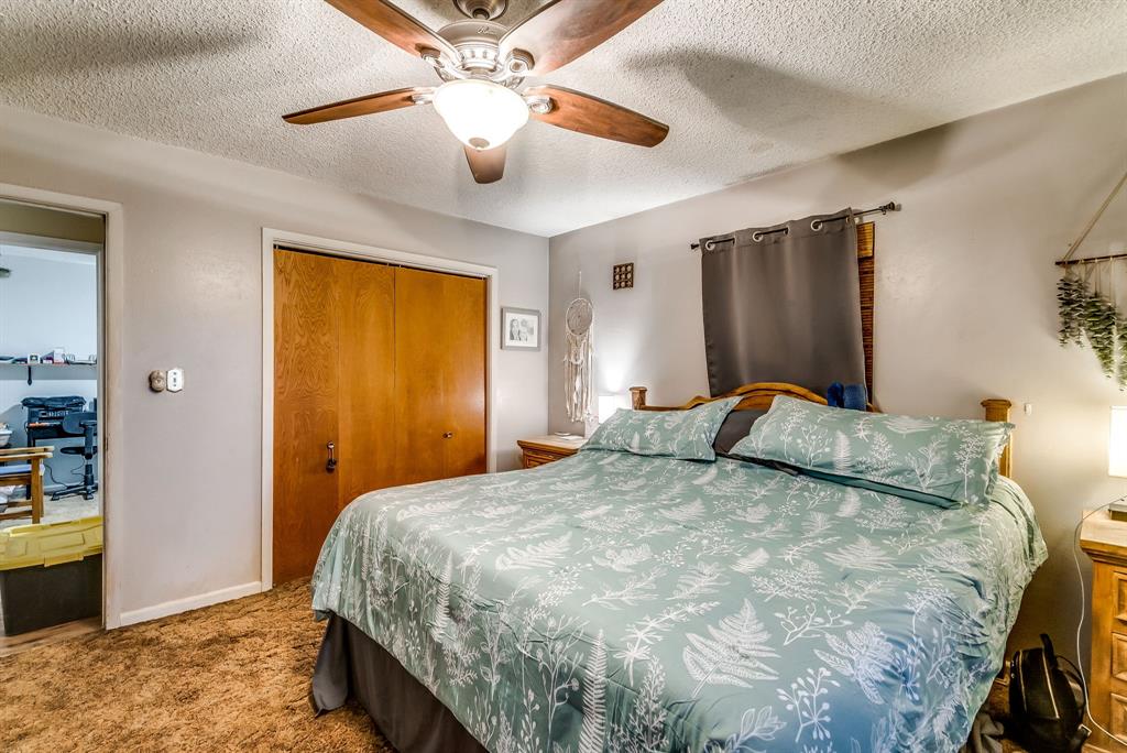 2912 Farm To Market 920 Weatherford, TX 76088 - Photo 14 of 28 Bedroom with a closet, carpet flooring, ceiling fan, a textured ceiling, and baseboards