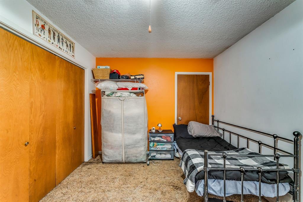 2912 Farm To Market 920 Weatherford, TX 76088 - Photo 18 of 28 Carpeted bedroom featuring a closet and a textured ceiling