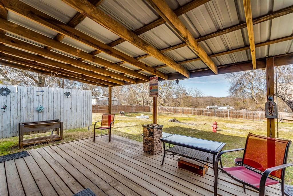 2912 Farm To Market 920 Weatherford, TX 76088 - Photo 24 of 28 Deck featuring a fenced backyard and a lawn
