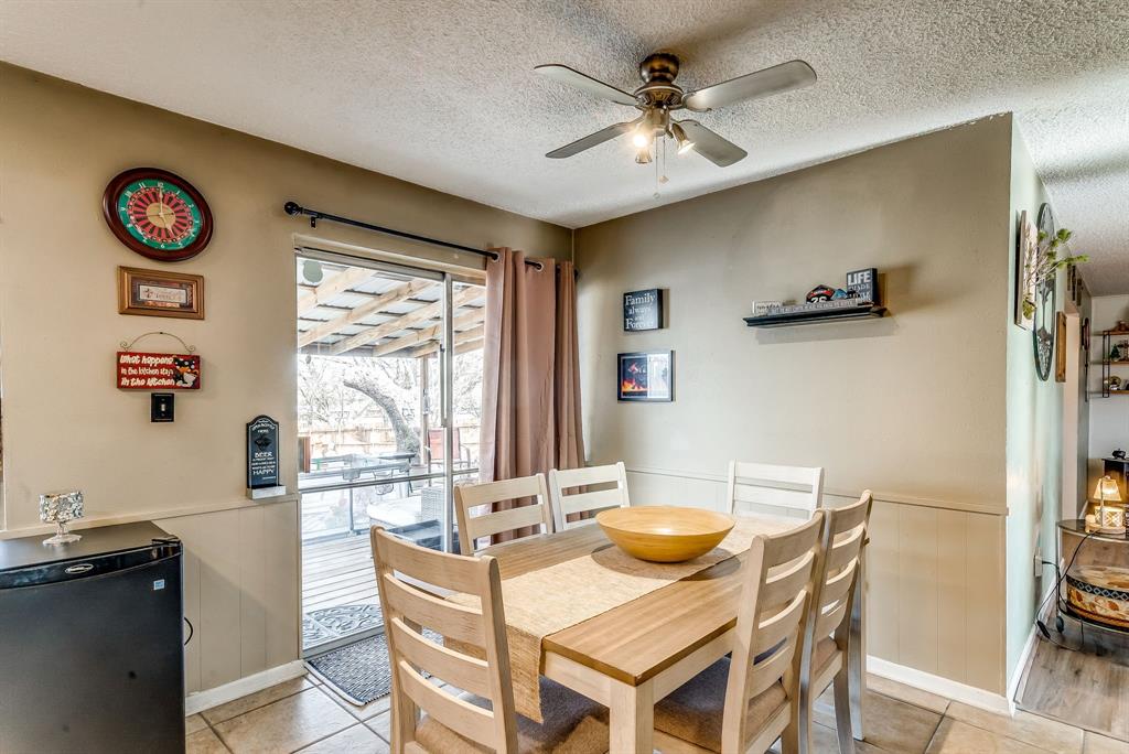 2912 Farm To Market 920 Weatherford, TX 76088 - Photo 8 of 28 Dining space featuring a wainscoted wall, a textured ceiling, light tile patterned flooring, and a ceiling fan