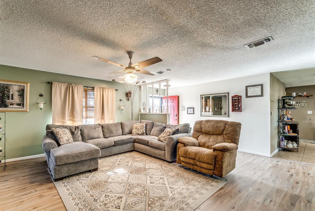 2912 Farm To Market 920 Weatherford, TX 76088 - Photo 10 of 28 Living room with visible vents, ceiling fan, a textured ceiling, wood finished floors, and baseboards