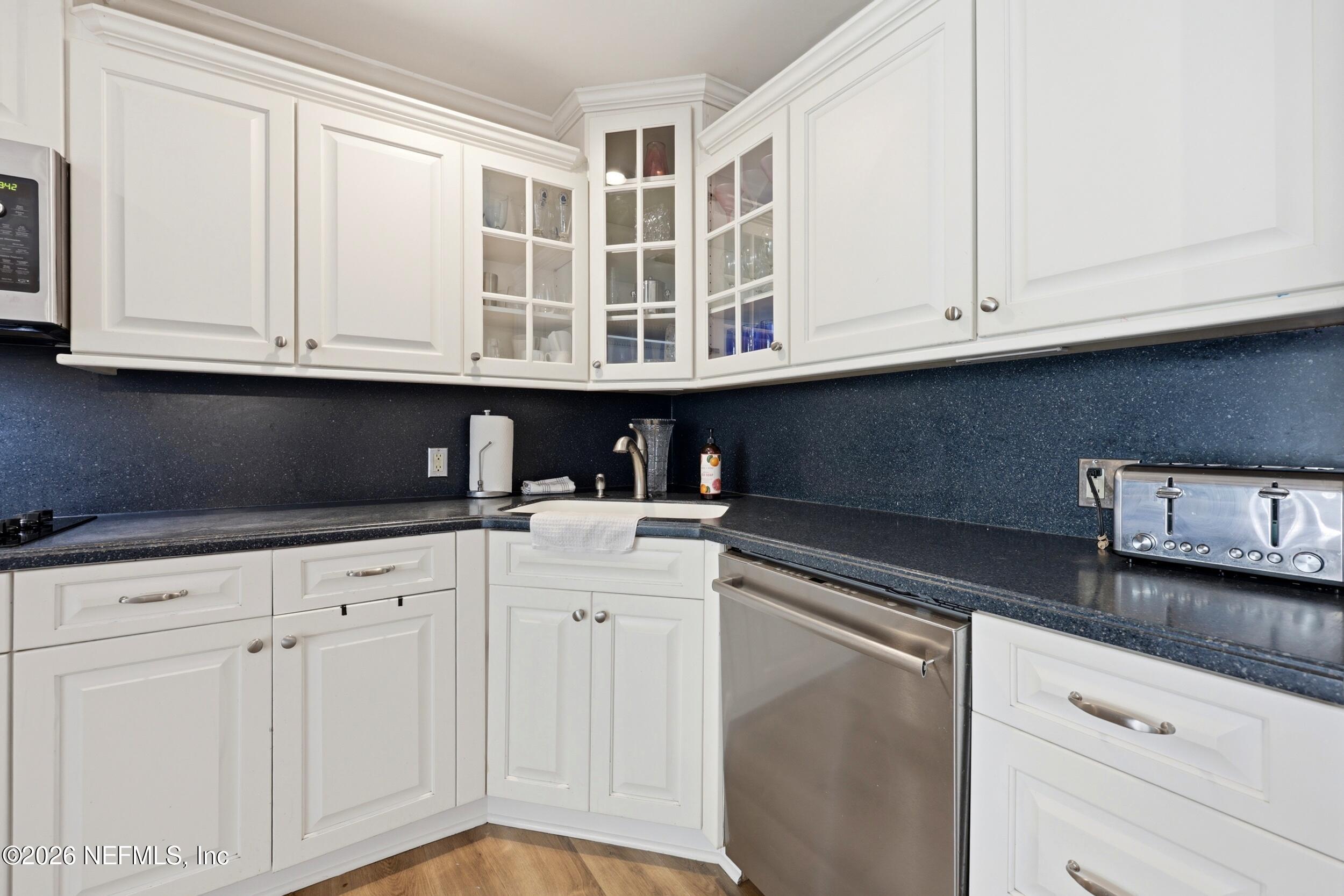 11627 Mandarin Terrace Road Jacksonville, FL 32223 - Photo 20 of 79 a kitchen with stainless steel appliances granite countertop a sink and dishwasher with white cabinets